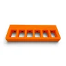 Orange magnetic 9mm magazine holder, showing the magazine slots.